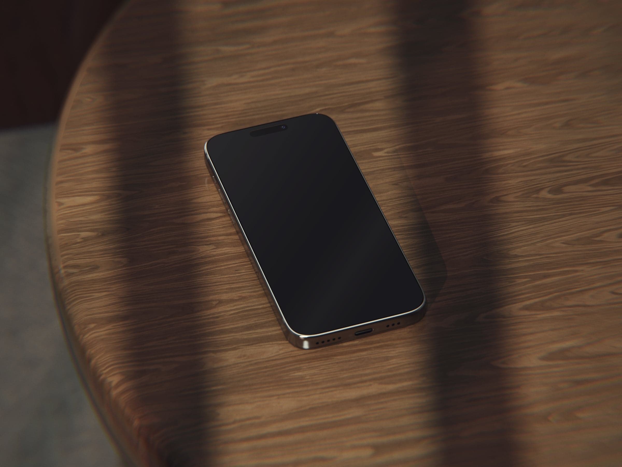 OAK 06 iPhone on a round oak stool in window shadows mockup preview